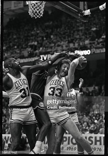 Celtics' Larry Bird fights for a rebound with 76ers' Sedale Threatt in 2nd quarter action of the game at Boston Garden, 1/20. Celtics' went on to win...