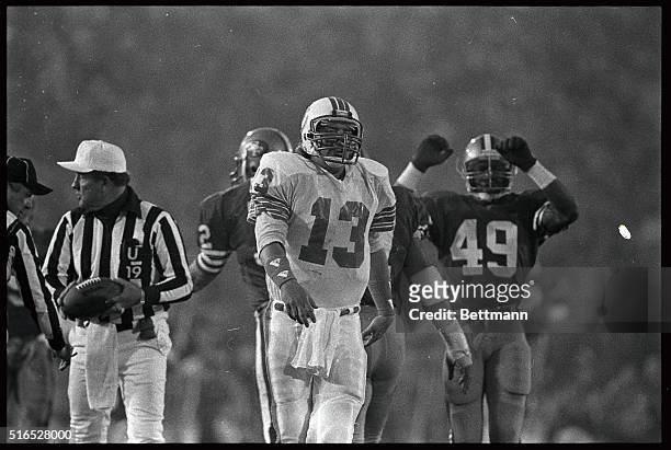Dan Marino walks back to the bench as 49er Jeff Fuller celebrates a sack, in the third quarter. The 49ers won 38-16.