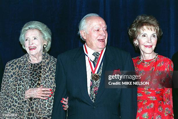 Legendary comedian and entertainer Bob Hope , his wife Dolores and former First Lady Nancy Reagan react as gathered media sing "Happy Birthday" to...