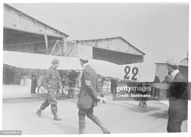 Louis Bleriot , French aviator, inspecting plane before departure.