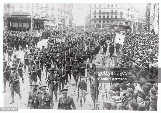 Down streets strewn with flowers between great crowds and a guard of honor the Batallion Infante, crack troops of the Spanish army, returned to...