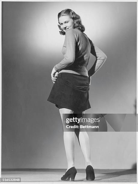 Portrait of a young woman in seamed stockings.