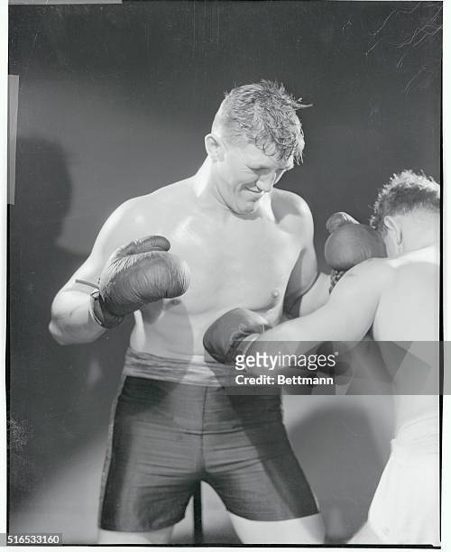 Unknown boxer taking a punch to the stomach.