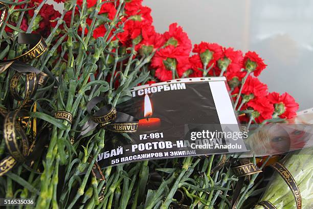 Flowers lie on a desk outside the airport building in Rostov-on-Don where a plane crashed killing all 62 people onboard on March 19, 2016. A Dubai...