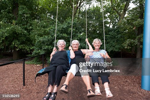 Senior girlfriends enjoying themselves on a swing Senior girlfriends enjoying themselves on a swing