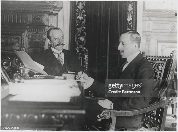 King Weighs Questions of State. His majesty Alphonso XIII of Spain seen at his desk in the days of the old regime.