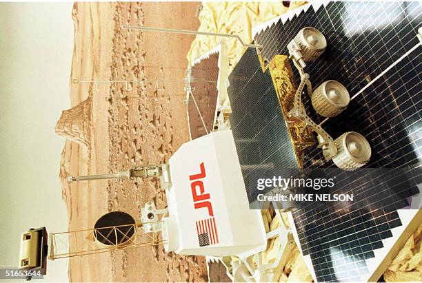 This photo shows a replica of the Mars Pathfinder "Sojourner" atop one of the solar panel petals 05 July with the Lander's cameras visible at the top...