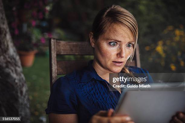 woman using smart device. - surprise fotografías e imágenes de stock