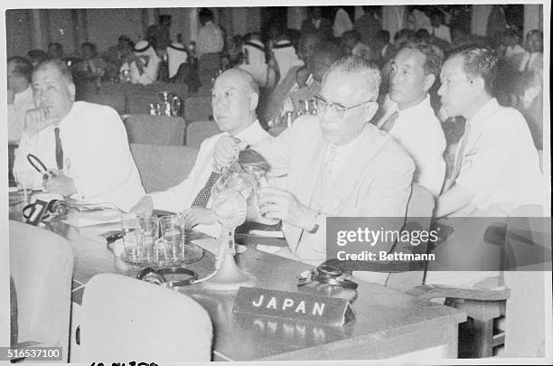 Bandung, Java, Indonesia: Japanese chief delegate at the African Asian Conference in Bandung. Mr. Takasaki has become thirsty. April 1955.