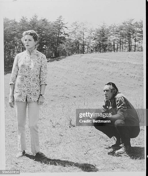 Taking Five, Gatlinburg, Tenn.: Ingrid Bergman and Anthony Quinn, each of whom have won Oscars, look somber during a break in the filming of Columbia...