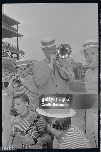 Baseball commissioner Bowie Kuhn plays trombone with the Maury Wills Base Steelers at 60th anniversary ceremonies of Forbes Field prior to game...