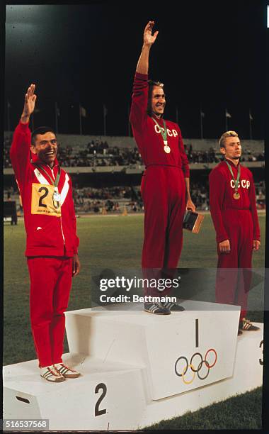 Mexico City: Winners of the 20 Kilometer walk, with their medals. Winner in center is Russia's Vladimir Golubnichiy, second place winner is Mexico's...