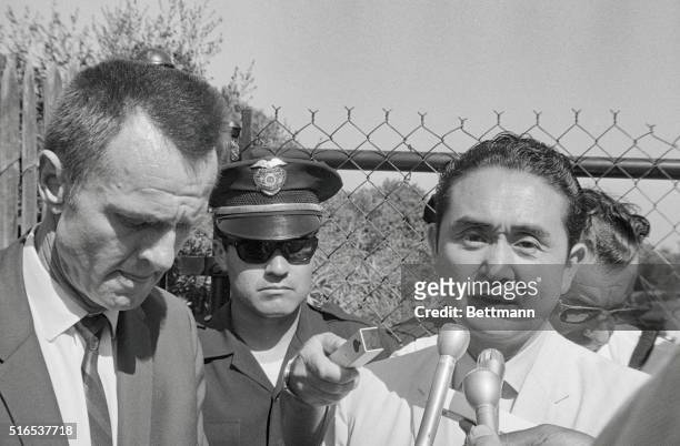 Los Angeles, California: LA County coroner Thomas Nogouchi and LAPD Lt. Robert Madlock talk with newsmen outside the home of actress Sharon Tate who...