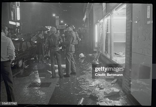 Provincial Police officer arrests a looter on Ste Catherine Street here late 10/7. The street was the target for smashed windows and looting...