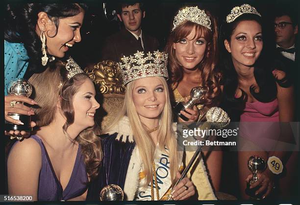 London: Newly crowned Miss World 1969, 20-year-old Eva Rueber-Staier receives congratulations from runners-up: Gail Renshaw , Christa Margraf ; and...