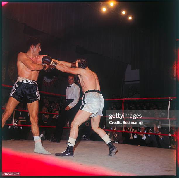 Rome, Italy: Italian middleweight boxing champ Nino Benvenuti an American challenger Don Fullmer start to mix it up during the first round of their...
