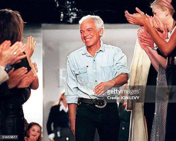 Fashion designer Ralph Lauren receives applause from models and guests after the showing of his Fall 1997 Collection 09 April in New York. Over 50...
