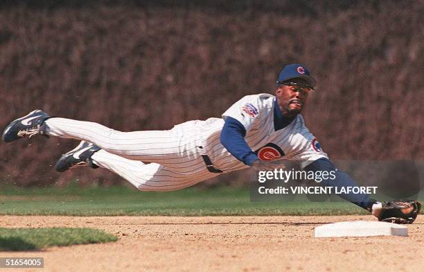 Chicago Cubs shortstop Shawon Dunston dives to catch a line drive hit by Colorado Rockies Eric Young to end the third inning, 15 April, at Wrigley...