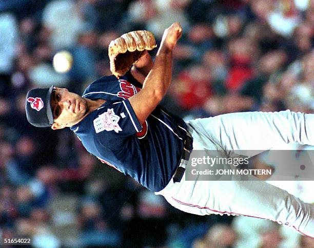 Cleveland Indians pitcher Chad Ogea attempts to throw out first base runner Darren Bragg of the Boston Red Sox 16 April in the fourth inning at...