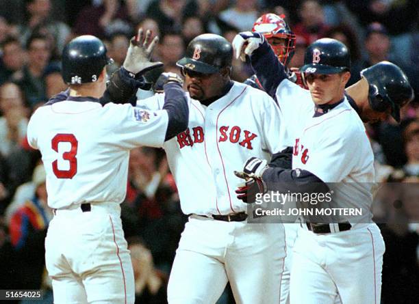 Boston Red Sox's Mo Vaughn is congratulated by team members Jeff Frye and Darren Bragg 16 April after hitting a three run homer in the fourth inning...