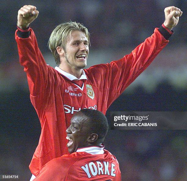 Forward Dwight Yorke and midfielder David Beckham of Manchester United jubilate after winning the final of the soccer Champions League against Bayern...