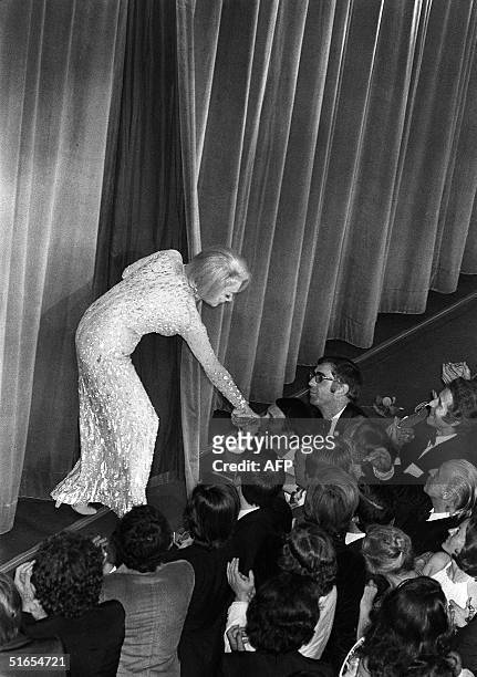 Film actress Marlene Dietrich , born in Berlin, shakes hands with the public after her performance at the Espace Cardin theater in Paris 20 June...