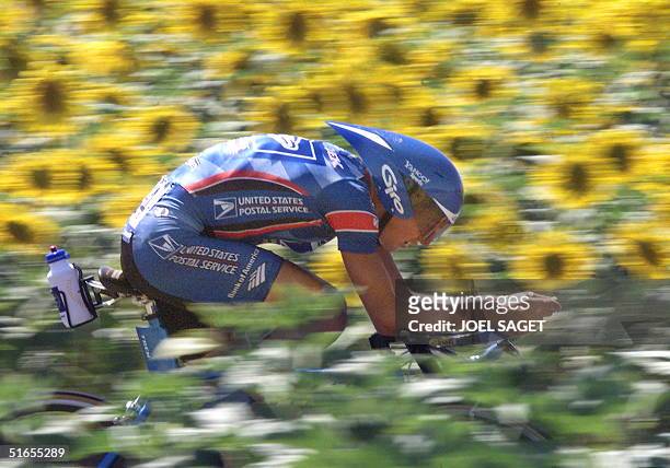 American Tyler Hamilton rides nearby a field of sunflowers during the 19th stage of the 86th Tour de France, an individual time-trial around the...