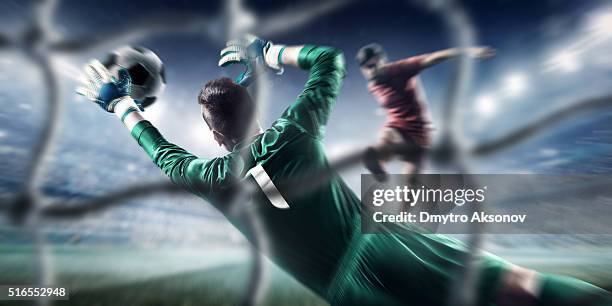 soccer game moment with goalkeeper - doelman stockfoto's en -beelden