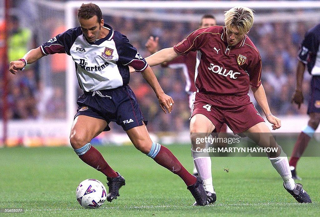 Paolo Di Canio of West Ham shileds the ball from S