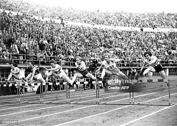 Athletes jump a hurdle in the final of the 80m hurdles, Helsinki olympics, 26 July 1952. Australian athlete de la Hunty won the gold medal. She also...