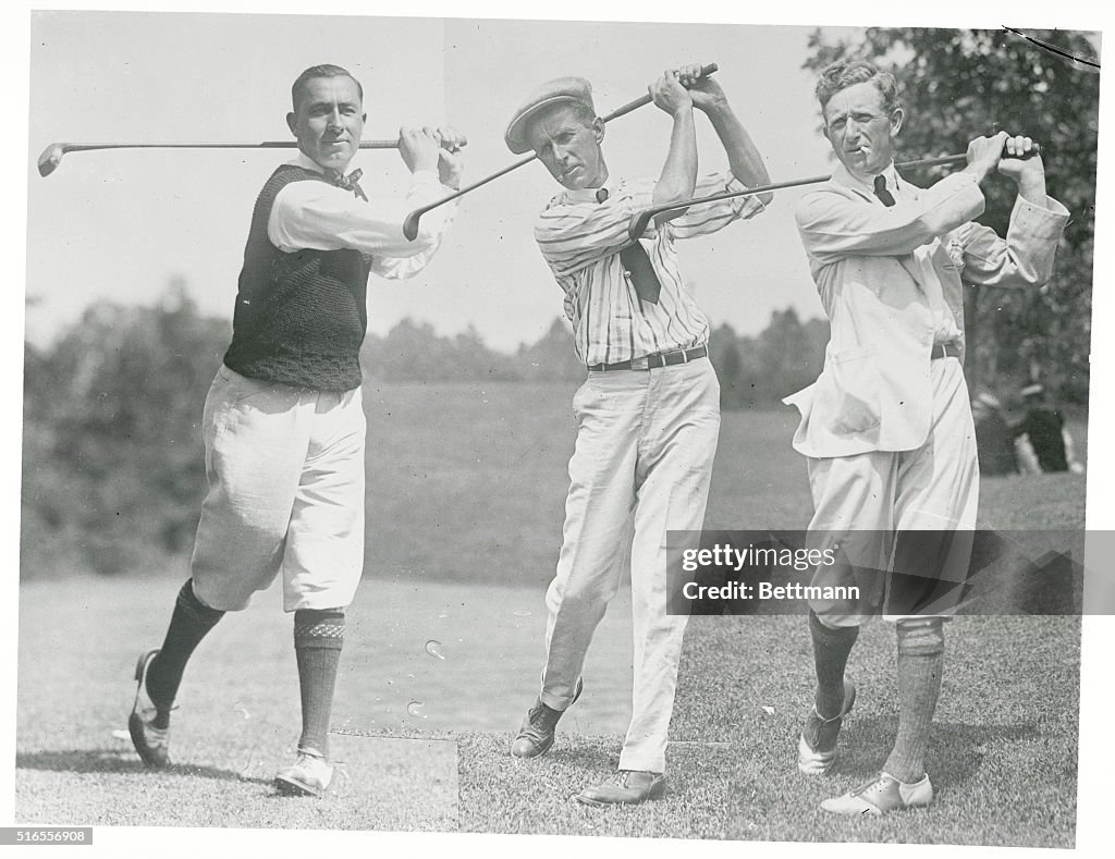 Golfers Posing with Golf Clubs