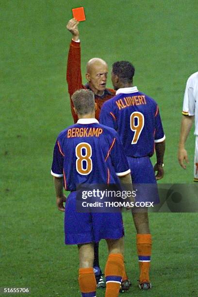 Dutch forward Patrick Kluivert is expelled by the referee Pierluigi Collina as teammate Dennis Berglamp looks on during the 1998 Soccer World Cup...