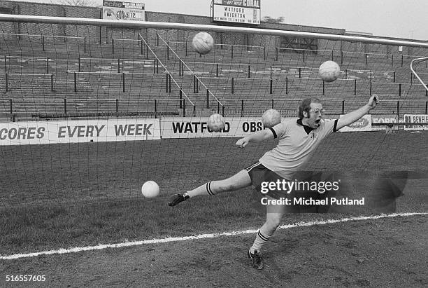 English singer-songwriter, and vice-president of Watford FC, Elton John, is overwhelmed by multiple shots on goal at the Vicarage Road stadium in...