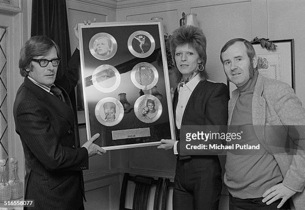 English singer-songwriter David Bowie with an award 'For Outstanding Musical Achievements', from RCA Records, January 1974. The award features...