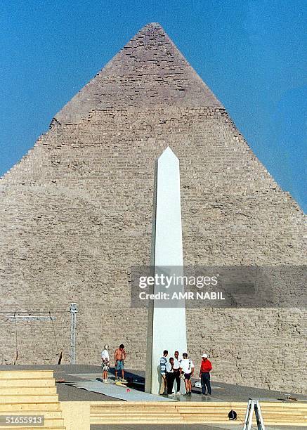 Huge obelisk, part of a the decor of the opera Aida which will be performed from 12 to 17 October, is erected in front of a Pyramid in Giza, near...