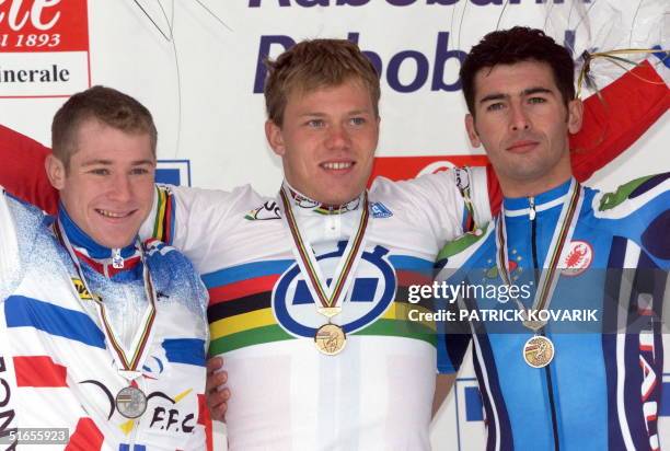 Third placed Frenchman Frederic Finot, winner Norway 's Thor Hushovd and second-placed Italian Gianmario Ortenzi pose on the winners stand after they...
