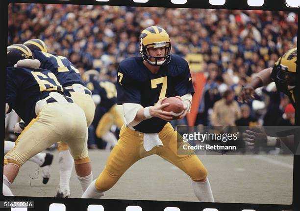 University of Michigan's quarterback Rick Leach seems to contemplate whether he should throw a pass.