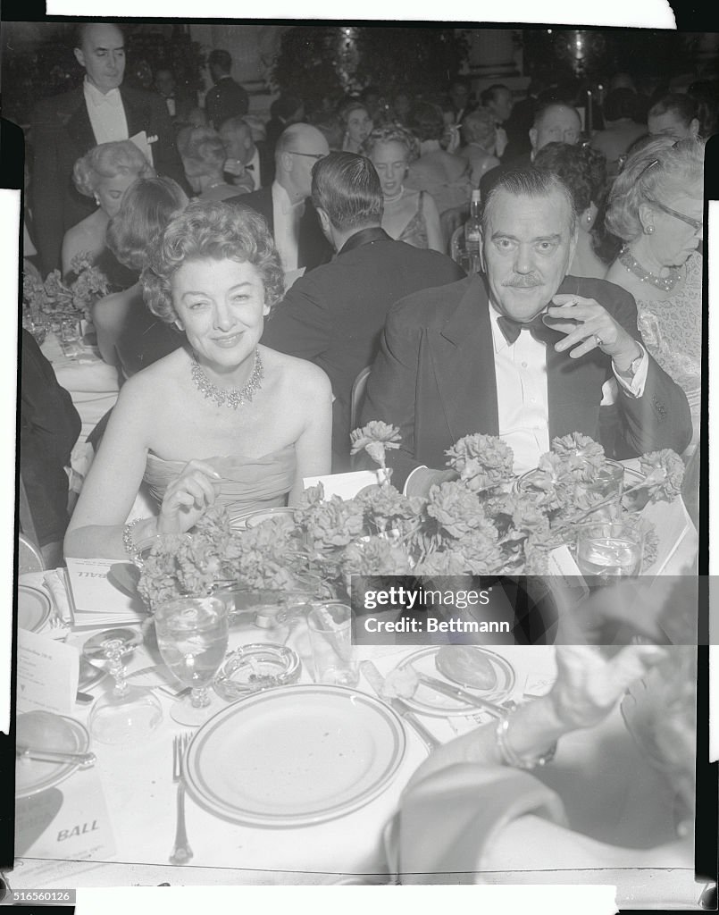Myrna Loy and Escort Sitting at Dinner Table