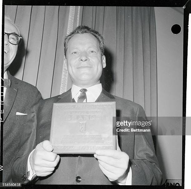 Mayor Willy Brandt of Berlin, holding the Freedom Award plaque, 6th October 1961. On the left is James J Wadsworth, Chairman of the Board of Freedom...