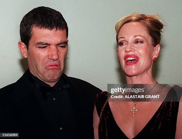 Spanish actor Antonio Banderas grimaces as he and actress-wife Melanie Griffith arrive at the British charity premiere of his new film, The Mask of...