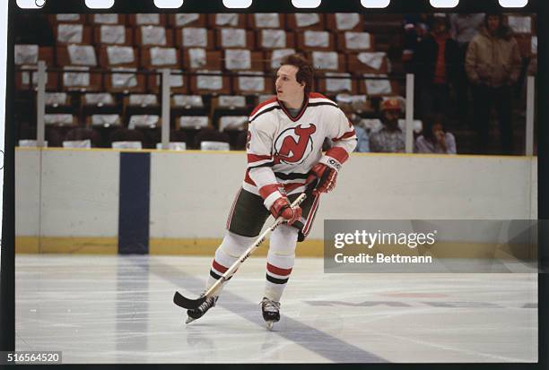 Looking off to the left, Joe Cirella, defense man for the New Jersey Devils, skates across the ice.