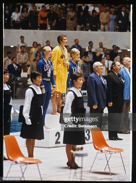 Medal ceremonies after Women's 100 meter free-style swim, Gold Medal winner in center is dawn Fraser of Australia, second place is Sharon Stouder of...