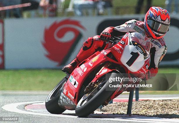 British biker Carl Fogarty revs his Ducati coming out from a sharp curve during the superbike world championships on the Kyalami racetrack outside...