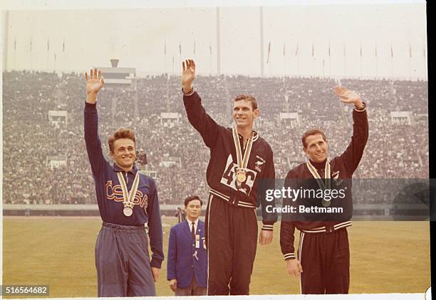 Victory ceremony following the 1,500 meter run. First place goes to Peter Snell of New Zealand, second to Josef Odiozil of Czechoslovakia, and third...
