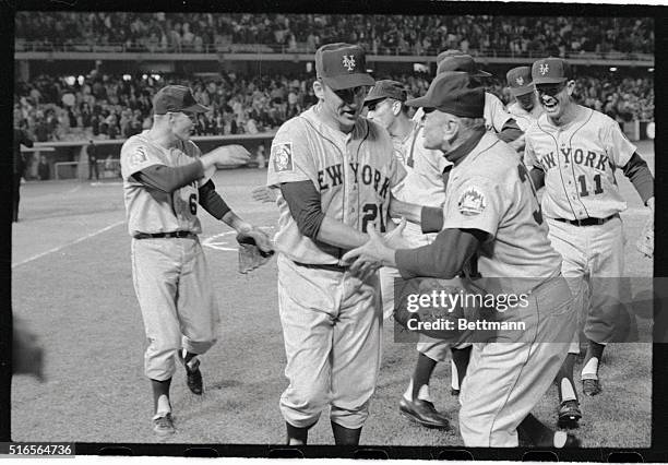 Veteran left hander Warren Spahn, is welcomed and congratulated by Mets' Manager Casey Stengel after the game here, when Spahn choked off a Dodger...