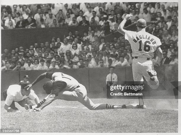 St. Louis: Pirates' 1st baseman Donn Clendenon stretches for a low throw to put on Cards' Phil Cagliano in the 6th inning of the 1st game of a double...