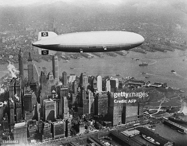 Image dated of the 30's showing German giant airship Hindenburg flying over Manhattan island in New York.