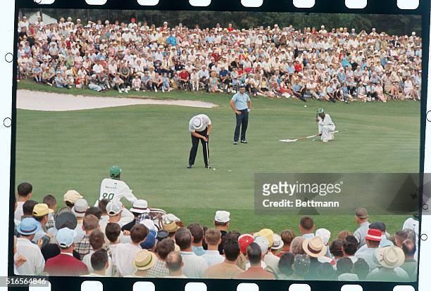 Augusta, Georgia: Jack Nicklaus lines up his putt on the 18th hole in the final round of the Masters Tournament today. He went on to sink the putt...