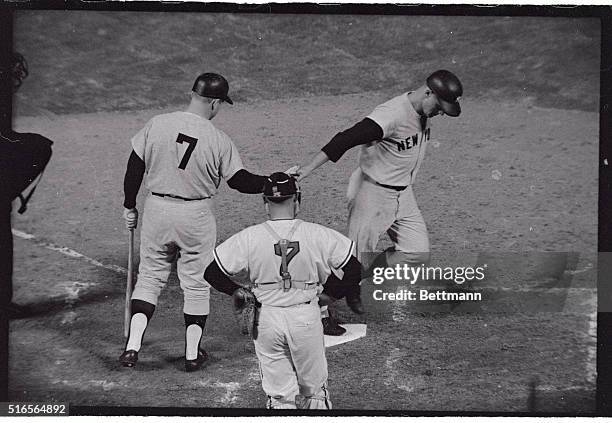 Roger Maris crosses the plate here after hitting his first home run of the 1965 season on April 15th, and is greeted by on-deck man Mickey Mantle in...