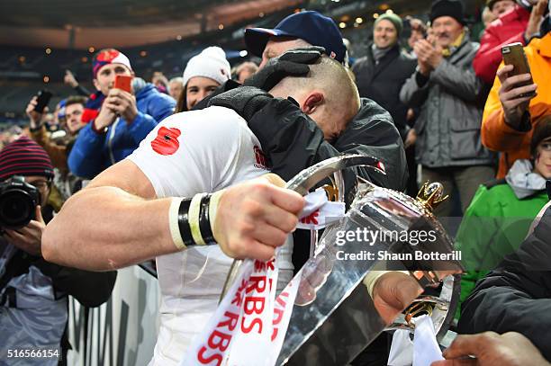 Mike Brown of England celebrates with the trophy following his team's 31-21 victory during the RBS Six Nations match between France and England at...